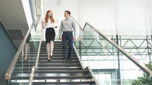 Young Car Salesman Telling About Features of Car To Female Customer