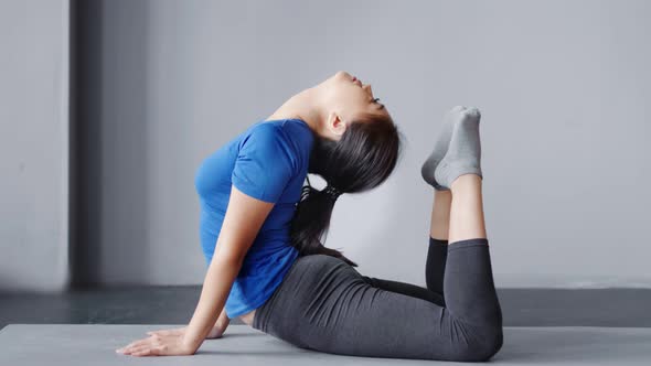 Asian Flexible Women Practicing Yoga in Studio Indoor Fitness Female with Perfect Stretching