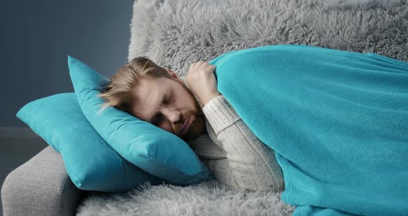 Tired Man Sleeping on Sofa