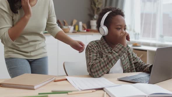 Boy with Headphones Studying at Home