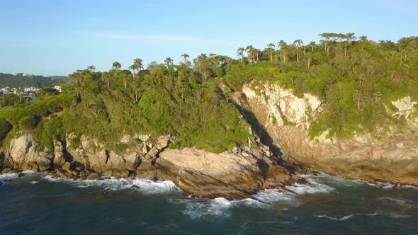 Aerial dolly left shot of the Trilha da Sepultura, a hiking area in Bombinhas, Brazil