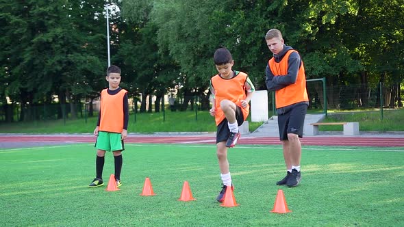 Football Coach Watching How His Pupils Doing Jumping Exercises During Workout