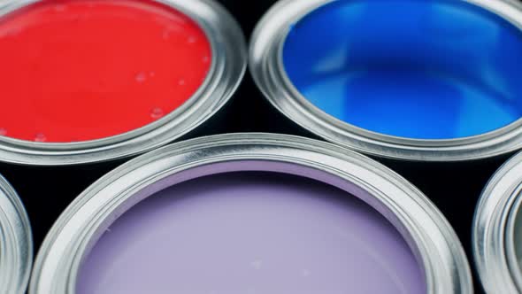 Open Multicolor Paint Cans on Grey Background, Top View