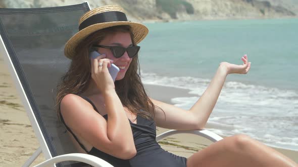 Beautiful Smiling Woman Lying on Deck Chair 