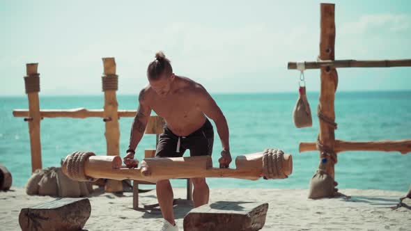 Man Training on the Beach in Eco Gym
