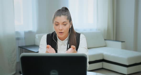 Concentrated Student with Ponytail Talks at Online Lecture