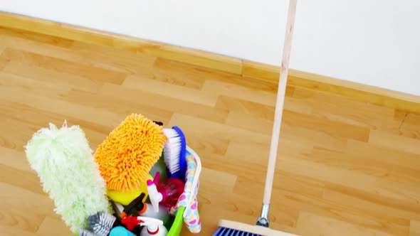 Various housekeeping supplies in a bucket