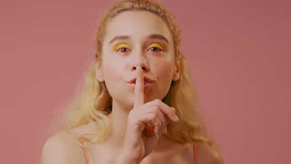 Portrait of Emotional Blonde Young Female Saying Shh, Asking for Silence