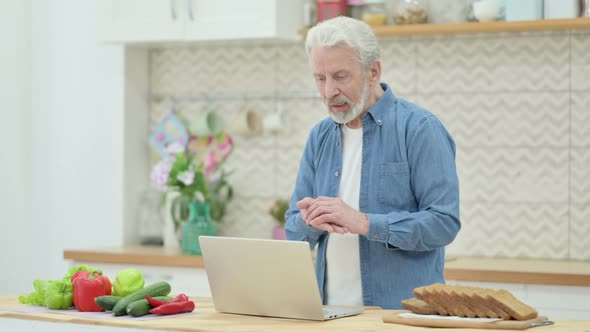 Old Couple Doing Video Call on Laptop in Kitchen