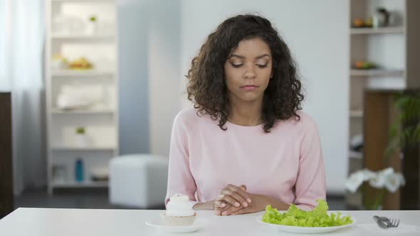 Beautiful Biracial Woman Choosing Between Salad and Sweets, Health, Choice