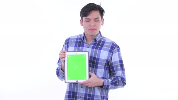 Stressed Young Asian Hipster Man Showing Digital Tablet
