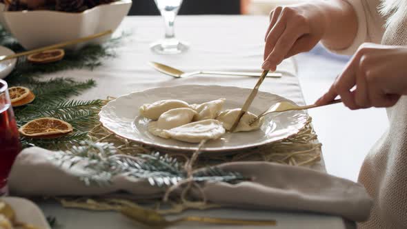 Woman eating dumplings at the Christmas Eve. Shot with RED helium camera in 8K