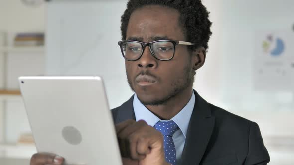 African Businessman Browsing on Tablet