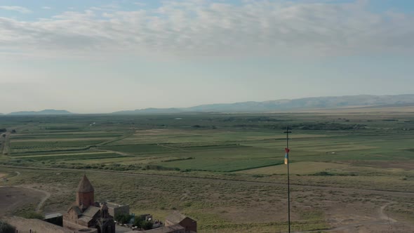 Aerial Drone Shot Pan Shot of Flag Waving on the Hill in Armenia