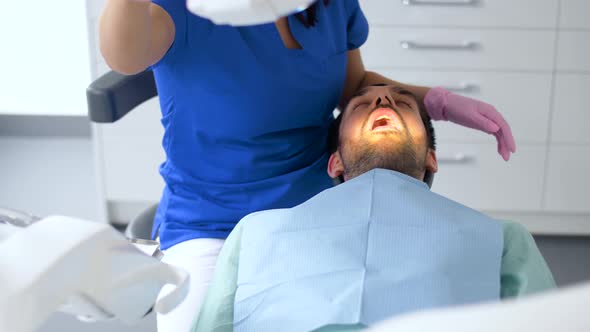 Dentist Checking Patient Teeth at Dental Clinic 