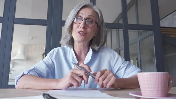 Senior Business Woman Talking To Camera in Virtual Video Call