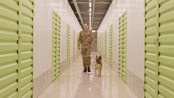 Security Man with Dog in Warehouse