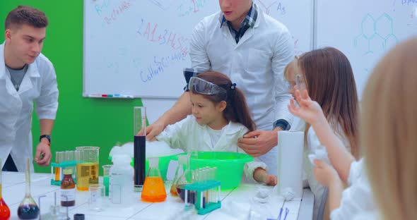 Teacher Teaching Group of Students in School Science Class