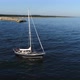 Aerial view of beautiful sailboat sailing out into the calm sea after sunrise. Baltic sea - VideoHive Item for Sale