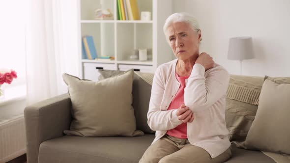 Senior Woman Suffering From Pain in Hand at Home