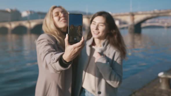 Portrait of Two Pretty Women Walking Outside