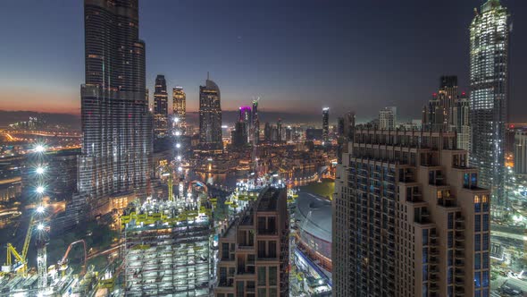 Panoramic Skyline View of Dubai Downtown Before Sunrise with Mall Fountains and Skyscrapers Aerial