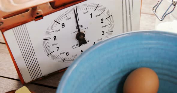 Clock and brown eggs on wooden table 4k