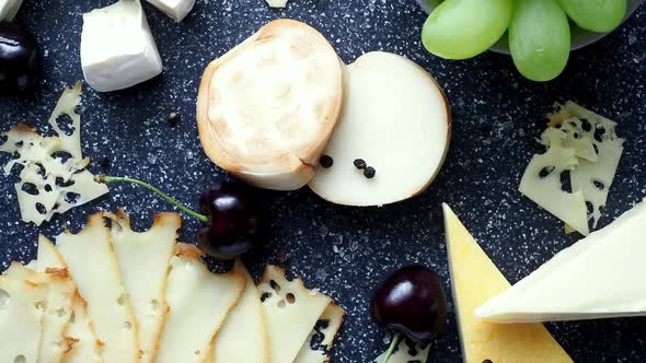 Cold appetizer. Cold cuts. Cheese on cutting board isolated on blue background