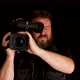 Concept idea: Bearded TV cameraman with professional video camera - VideoHive Item for Sale