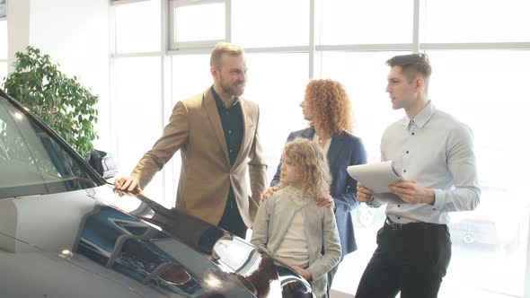 Happy Caucasian Family Now the Owners of New Car