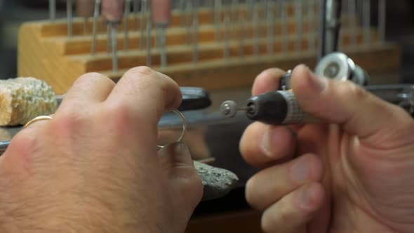 Goldsmith hands polishing a ring