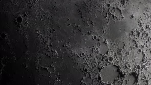 close-up of the moon. flight of the camera from the darkness to the illuminated surface of the moon alt