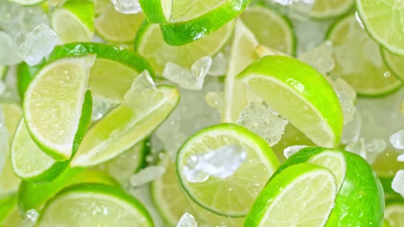 Super Slow Motion Shot of Flying Fresh Lime Slices and Crushed Ice Towards Camera at 1000Fps