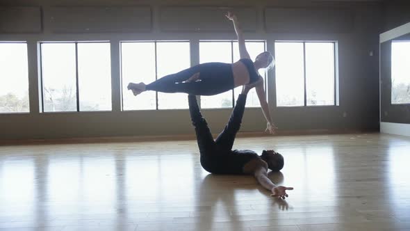 Partner Yoga performance done by two professional instructors