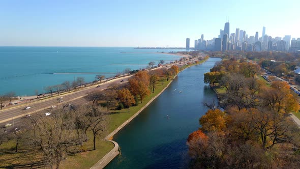 park in chicago during autumn, downtown in the background aerial footage above lake shore drive