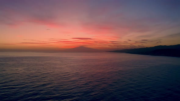 Etna Volcano silhouette over the Sea 