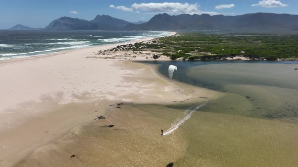 Beautiful Aerial Drone Shot of Kitesurfing Cruising on a Lagoon in Hermanus South Africa During a Pe