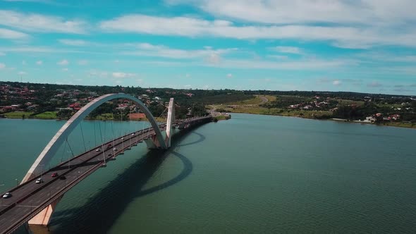 Beautiful aerial drone shot flying backwards next to the Juscelino Kubitschek Bridge in Brasilia