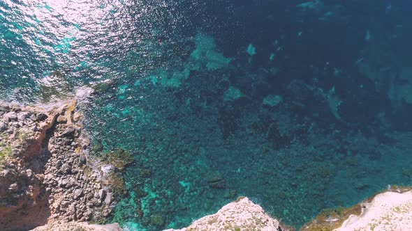 Transparent sea water near stony remote coast