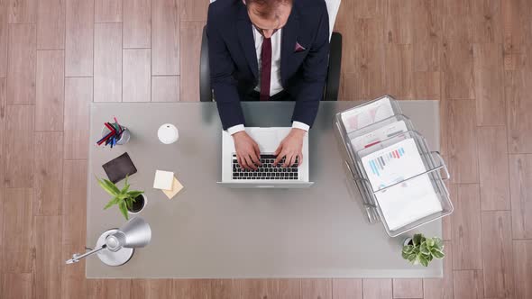 Top View of Young Businessman Typing on His Laptop