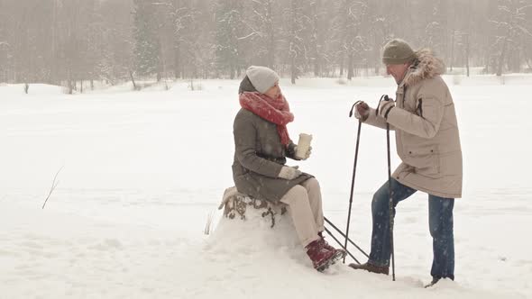 Couple on Break from Hiking in Winter alt
