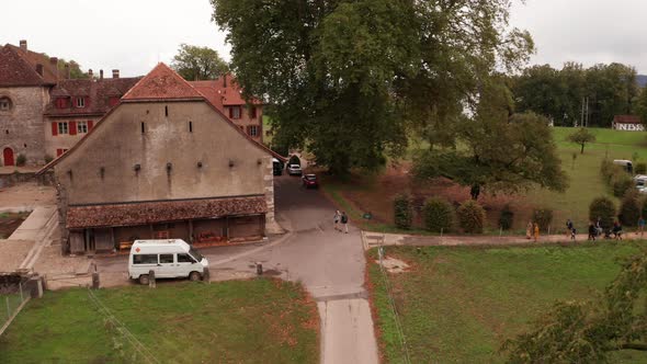 Aerial of people walking towards old monumental building