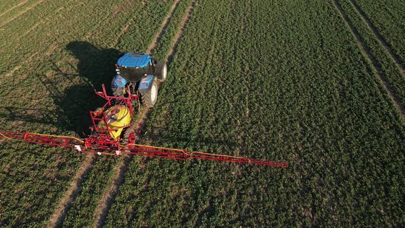 Tractor Spray Fertilizer on Agricultural Field Aerial View