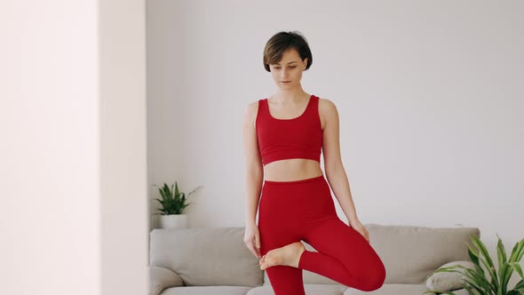 Woman in a Fitness Costume Is Doing Morning Yoga Exercise on a Mat