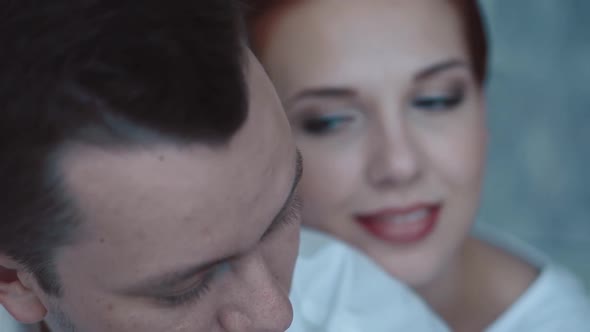 Young Beautiful Couple Sitting in the Morning on the Bed They Look at Each Other Thoughtfully