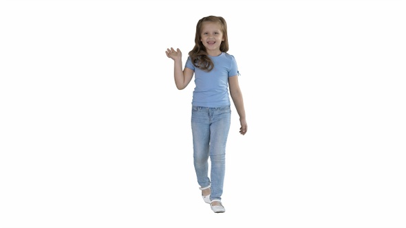 Cheerful girl greating and waving her hand while walking