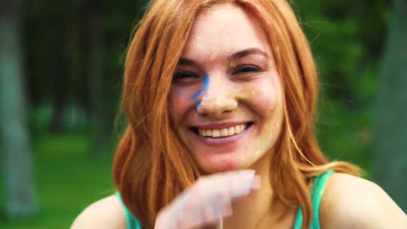 Young Red Haired Girl in Holi Festival Powder Laughing at Camera