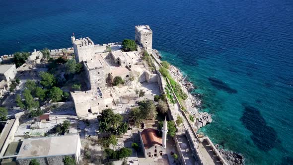 Amazing panoramic view from drone of full of yachts Bodrum harbour and ancient Kalesi castle.