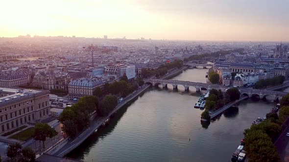 Descending drone flying over Seine river in Paris towards Ile de la Cite and La Samaritaine in recon