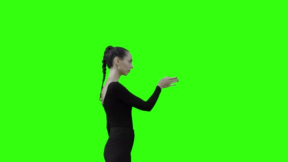 Young Woman Pressing on a Button with Green Screen.